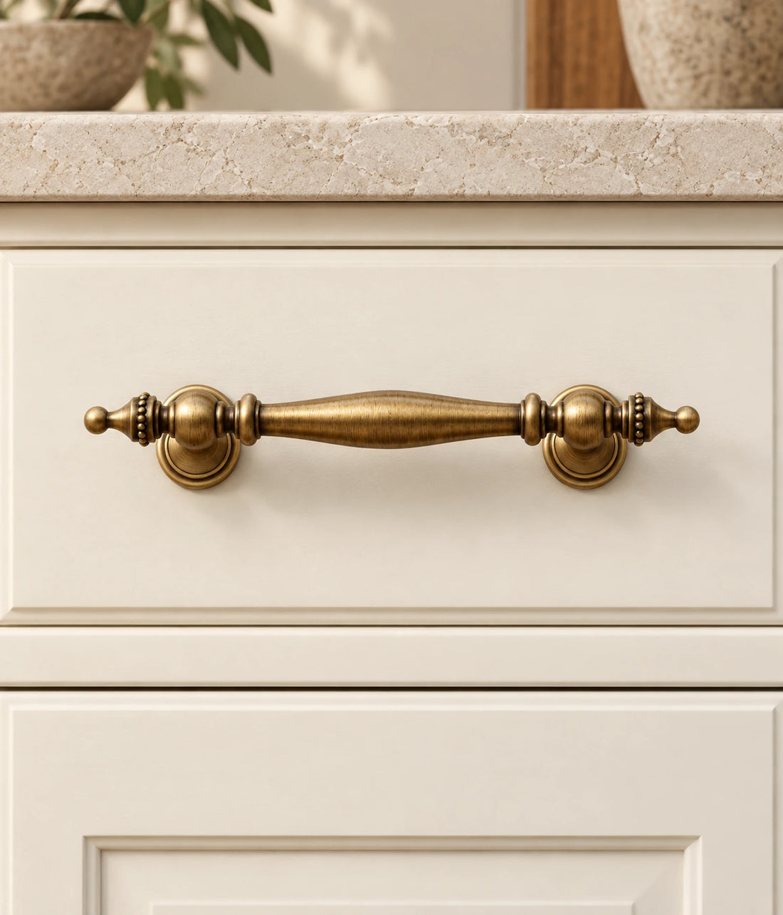 Antique Brass Beaded Spindle Pulls, Cup Pull & Knob on warm ivory limestone