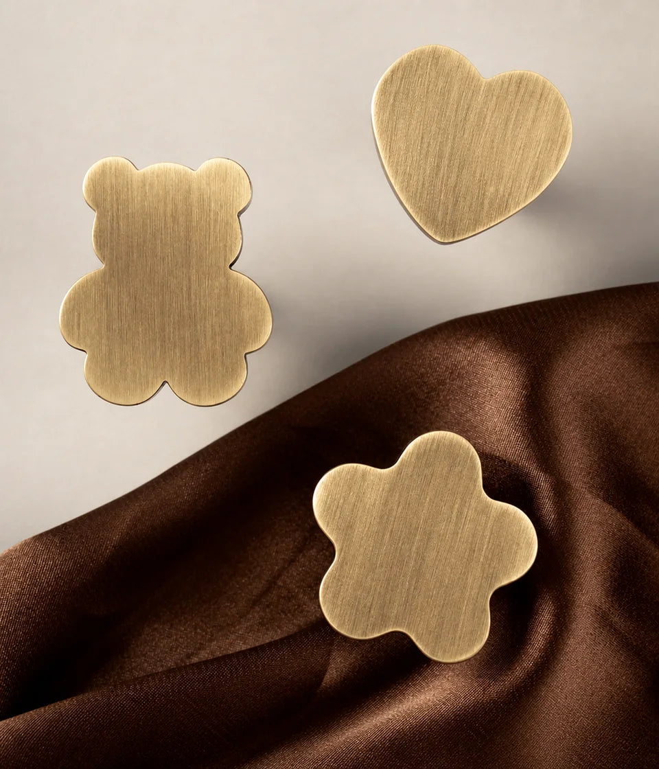 Bear, heart and rounded star brushed brass cabinet knob faces