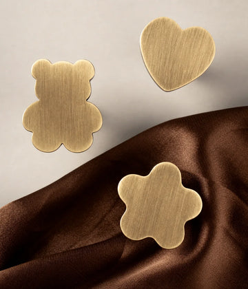 Bear, heart and rounded star brushed brass cabinet knob faces