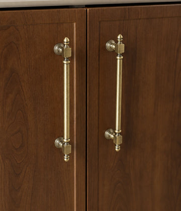 Antique brass Block-End cabinet pulls installed vertically on dark wooden doors