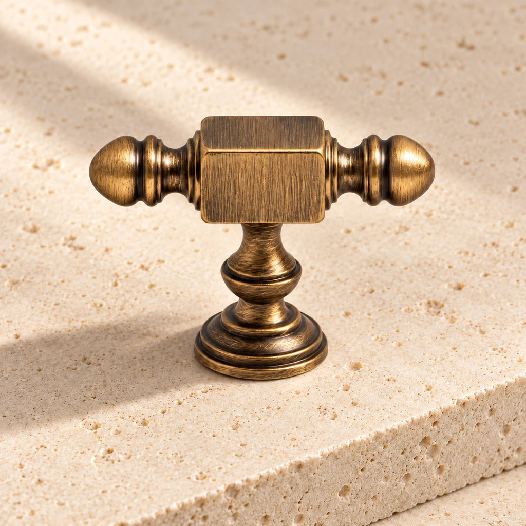 antique brass block end t knob limestone on pale limestone.