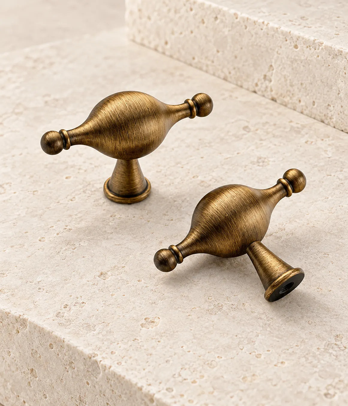 Two antique brass bulb-shaped T-knobs showing the decorative body and mounting post