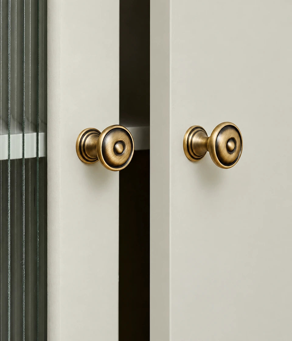Bullseye brass knobs with pedestal stems fitted to light cabinet doors