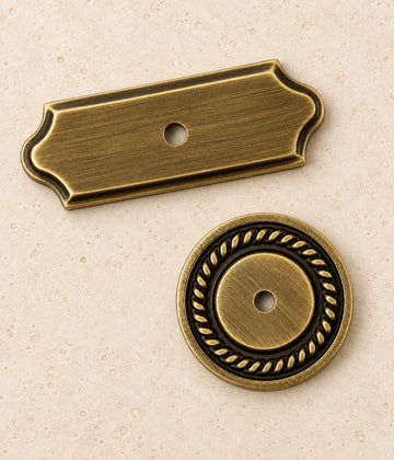 Antique Brass Cabinet Knob Backplates on warm limestone