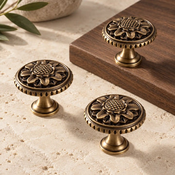 Antique brass rope-rim chrysanthemum cabinet knob on a premium neutral background