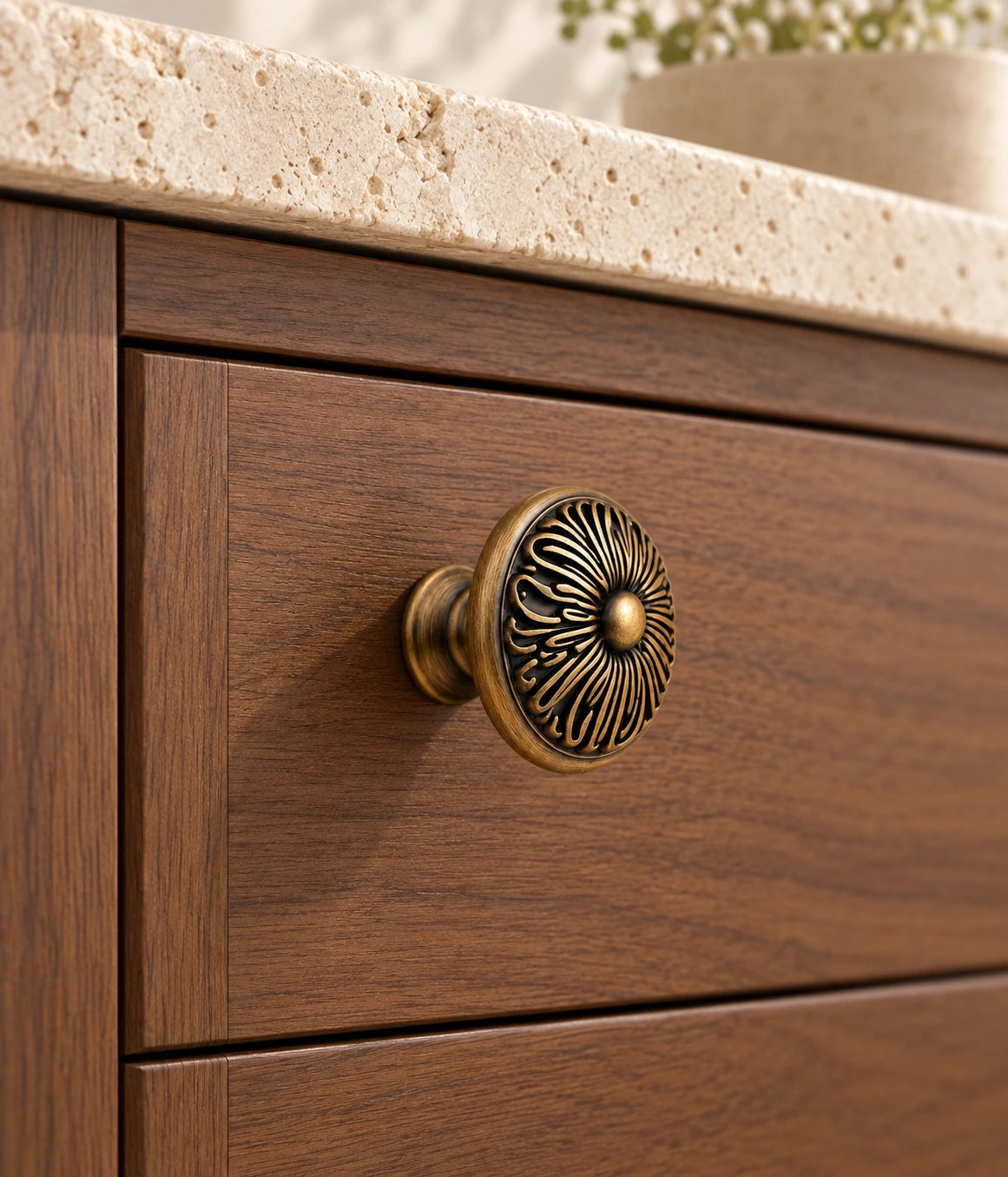 Antique Brass Chrysanthemum Cabinet Knob installed on a walnut cabinet drawer