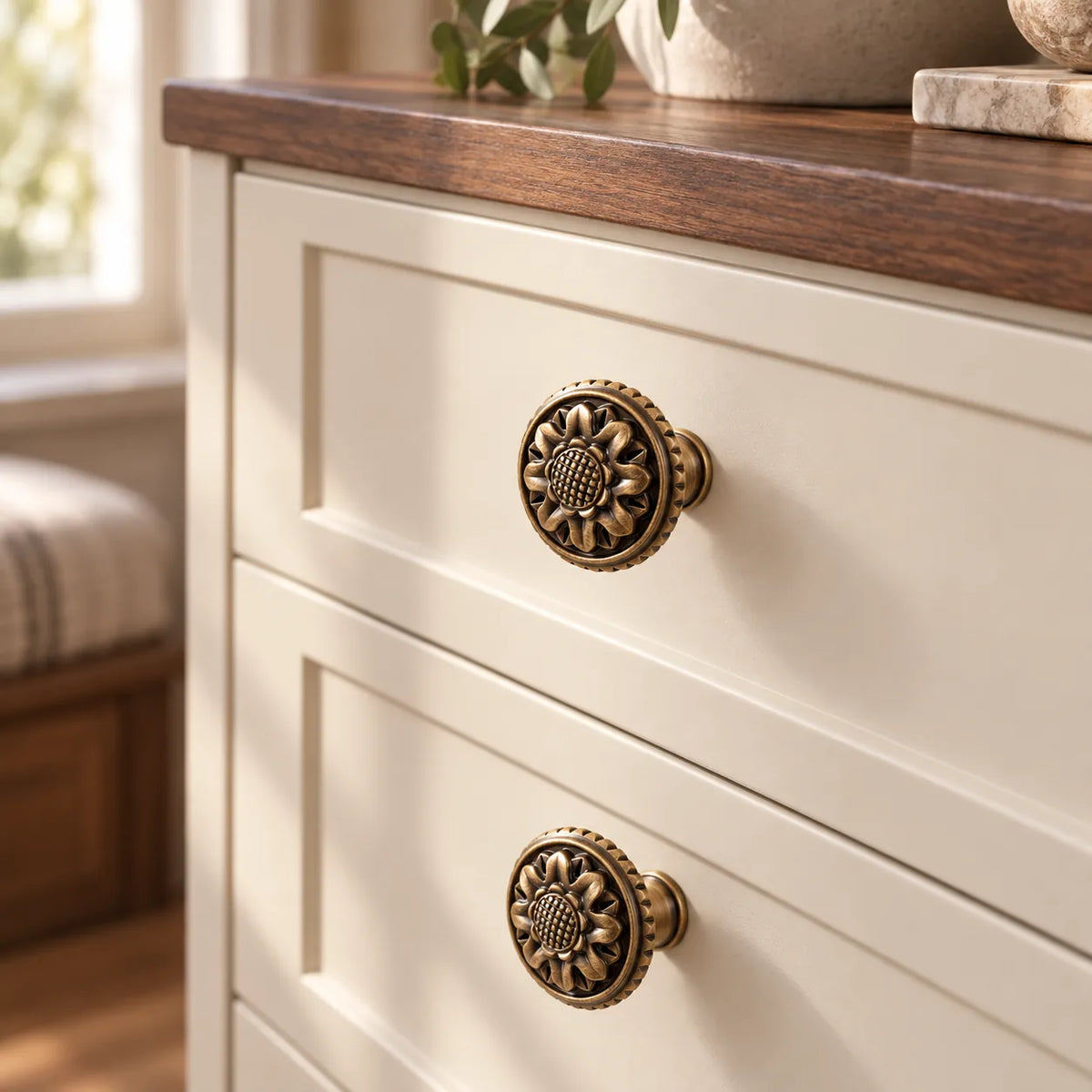 Antique brass rope-rim chrysanthemum cabinet knob installed on cabinetry
