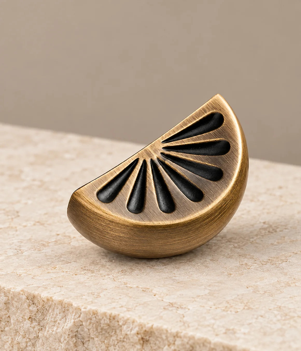 Close detail of the seven dark citrus segments and curved brushed brass rim
