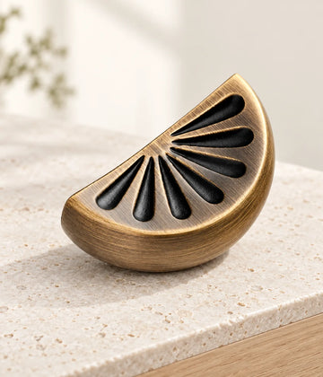 Antique brass citrus slice cabinet knob on a cream limestone plinth