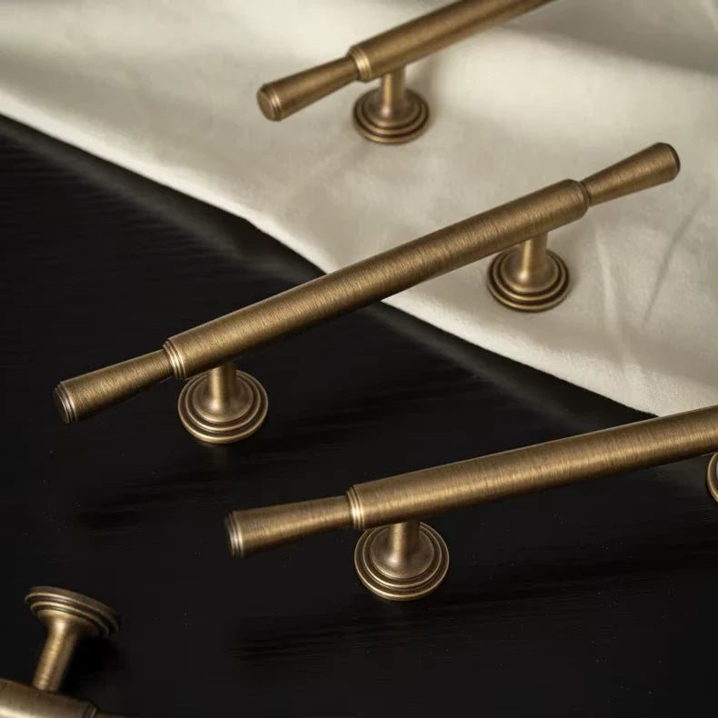 Antique brass classic bar pulls showing tapered ends and round bases