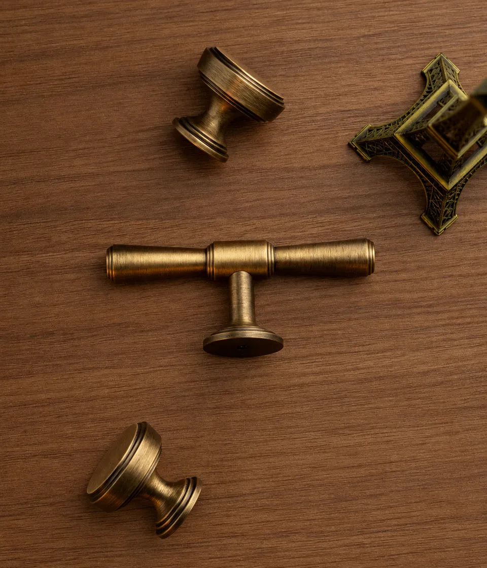 Antique brass T-knob and round cabinet knobs with stepped bases