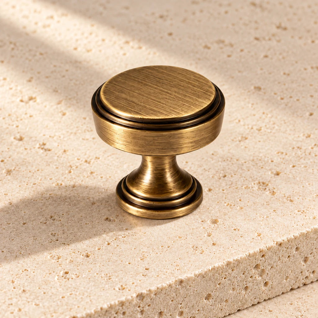 antique brass classic round knob limestone on pale limestone.