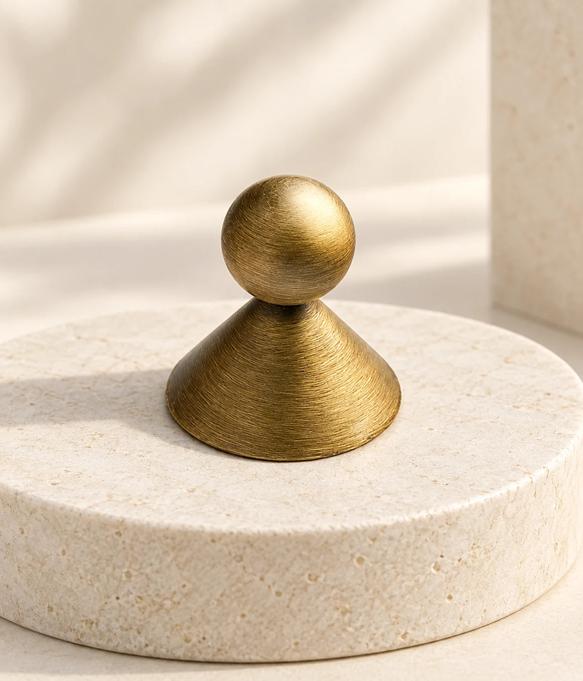 Close view of circular brushing on an antique brass conical-base ball knob