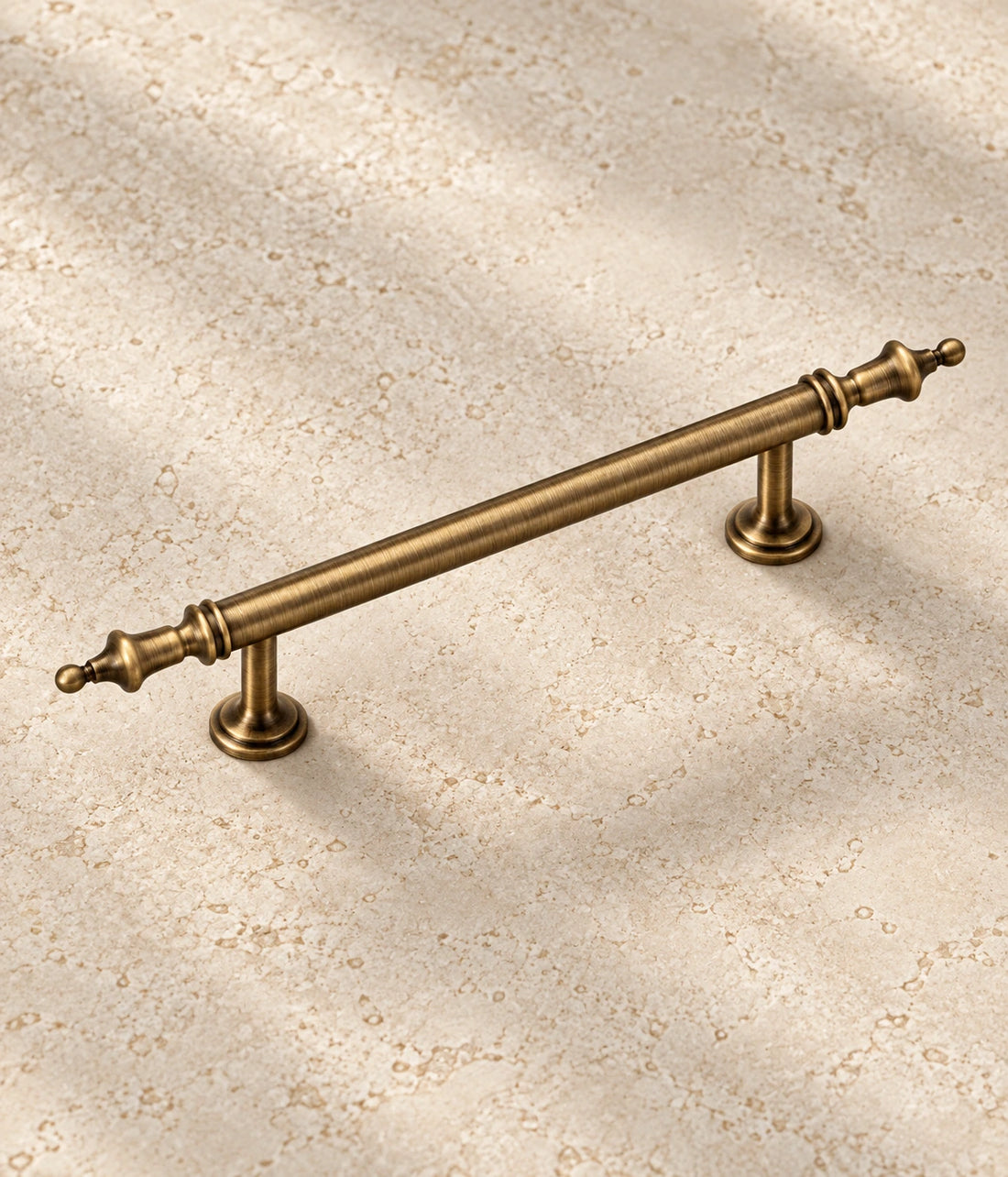 Antique Brass Crown Cabinet Pulls on warm ivory limestone