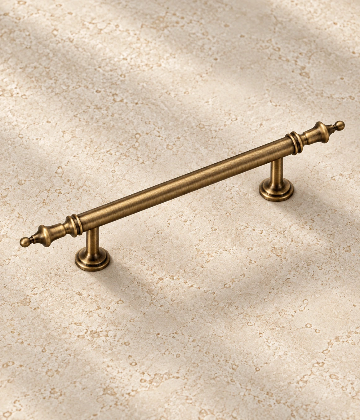 Antique Brass Crown Cabinet Pulls on warm ivory limestone