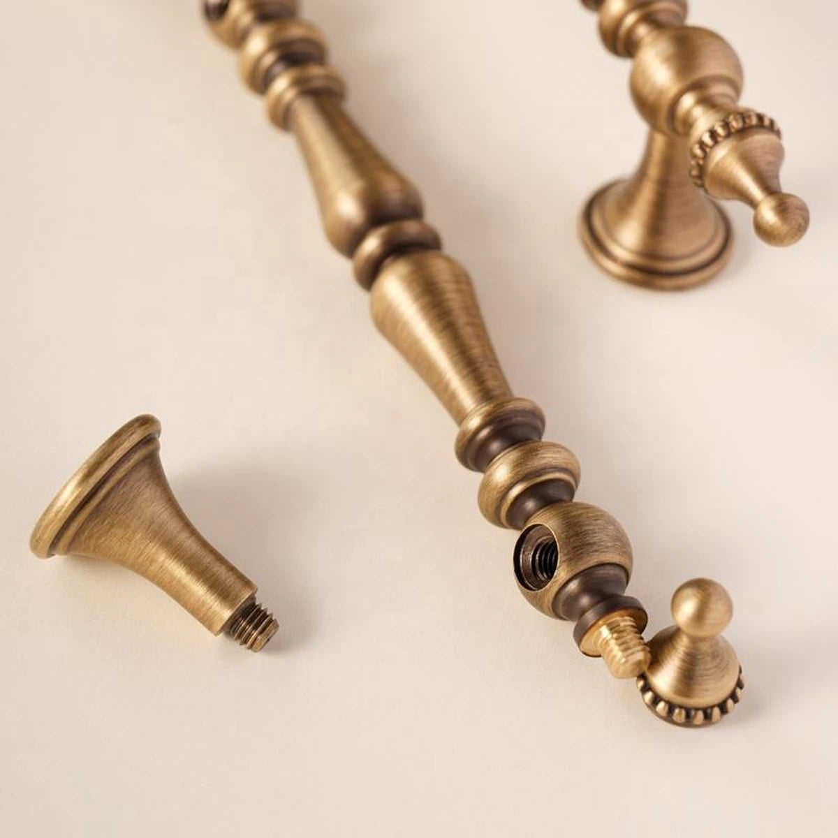 Threaded connection detail on a disassembled solid brass crown finial pull