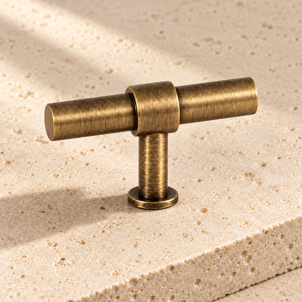 antique brass cylinder knob limestone on pale limestone.