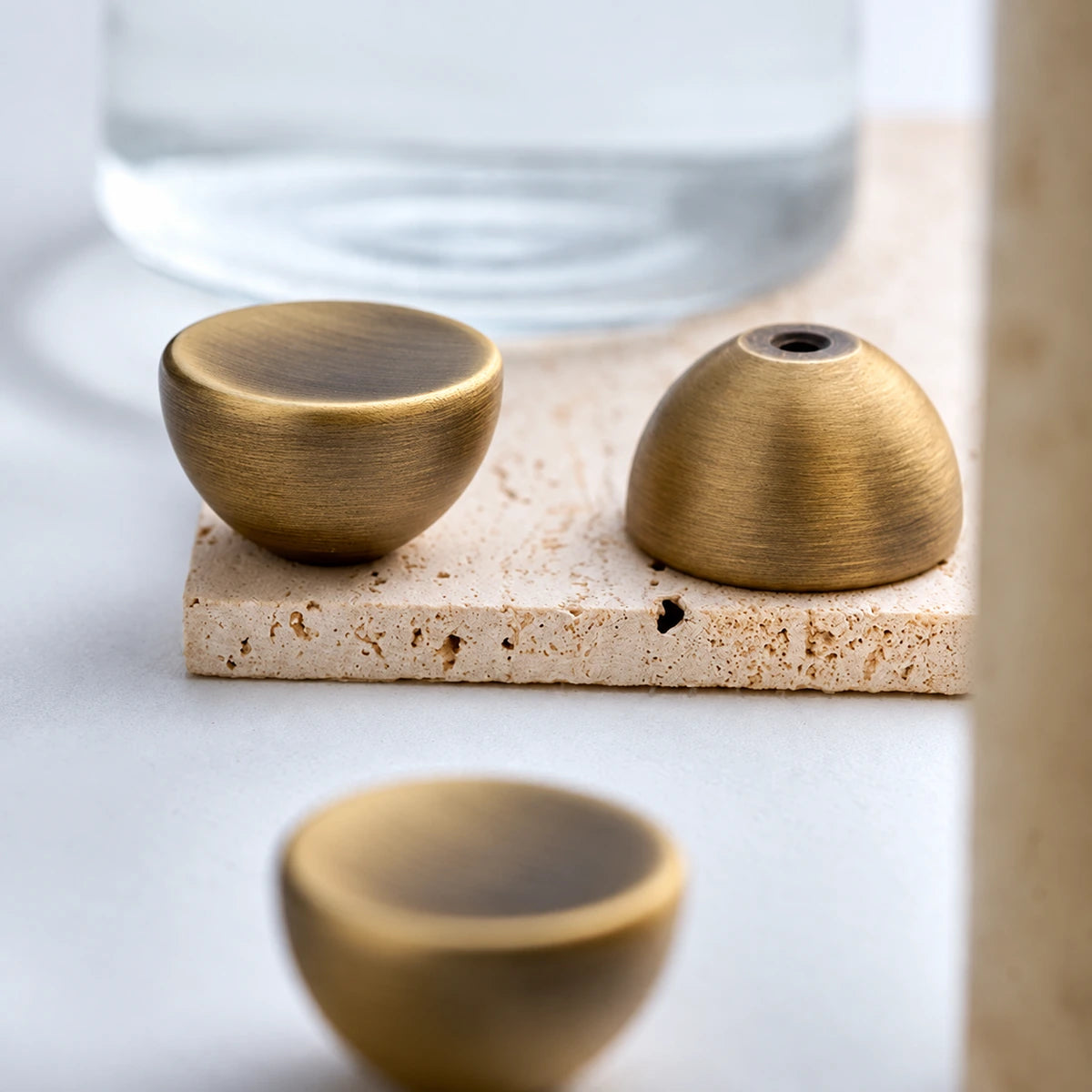 Front and reverse views of the dished brass knob and its mounting hole