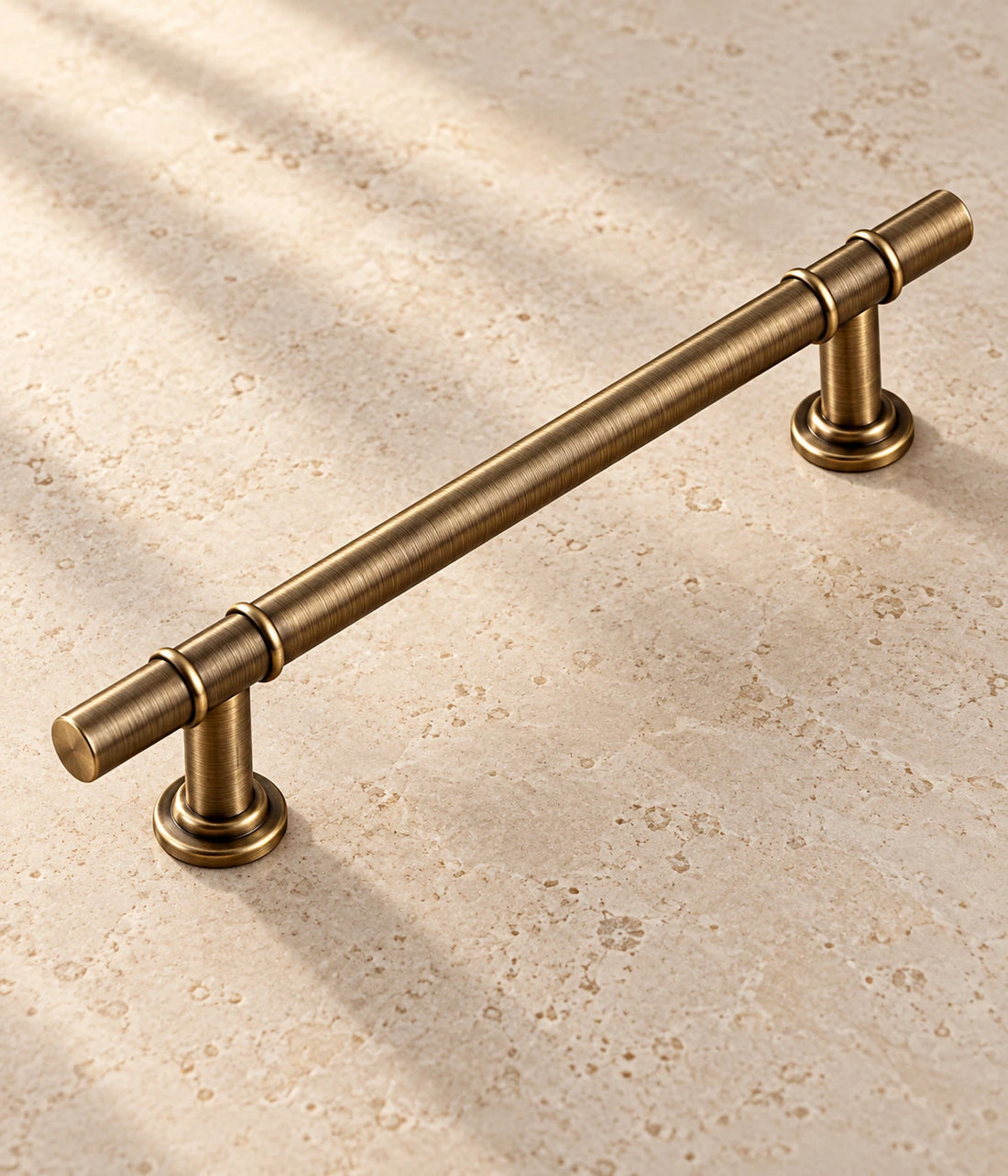 Antique Brass Double Collar Cabinet Pulls & T-Knob on warm limestone
