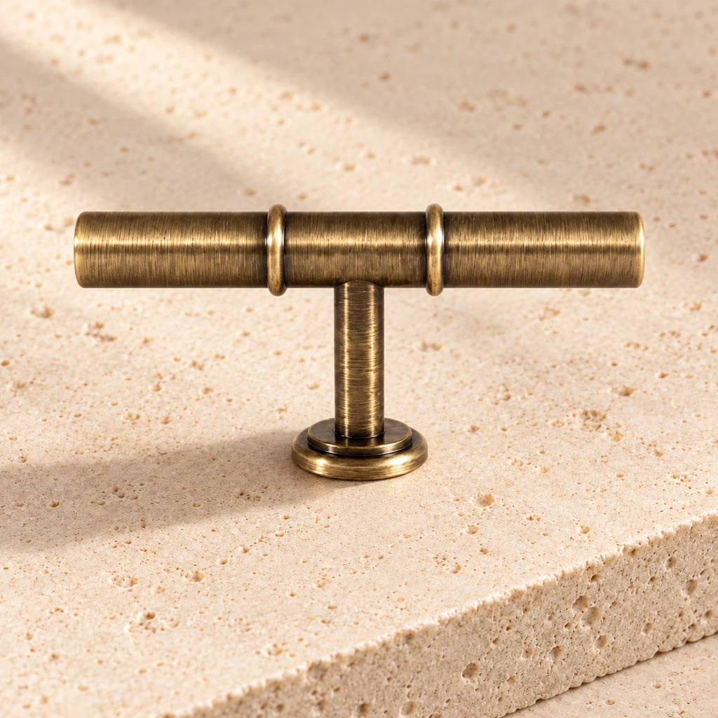 antique brass double collar t knob limestone on pale limestone.