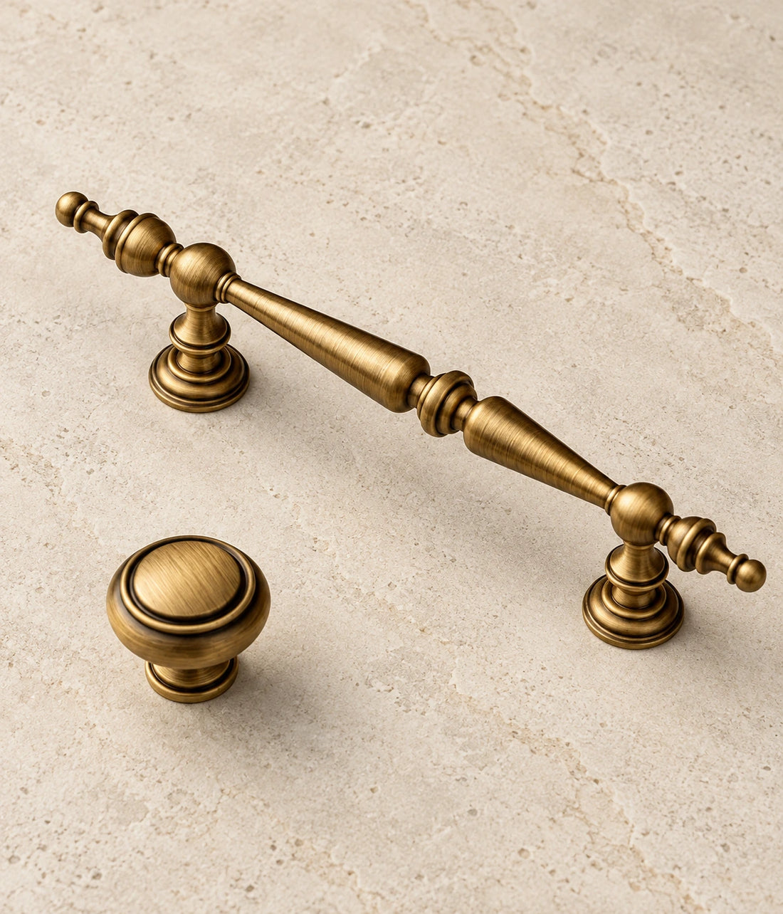 Antique Brass Double-Spindle Cabinet Pulls & Knob on warm ivory limestone