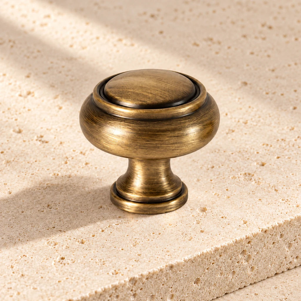 antique brass double spindle knob limestone on pale limestone.