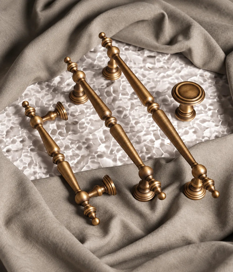 Finial cabinet handle family in antique brushed brass
