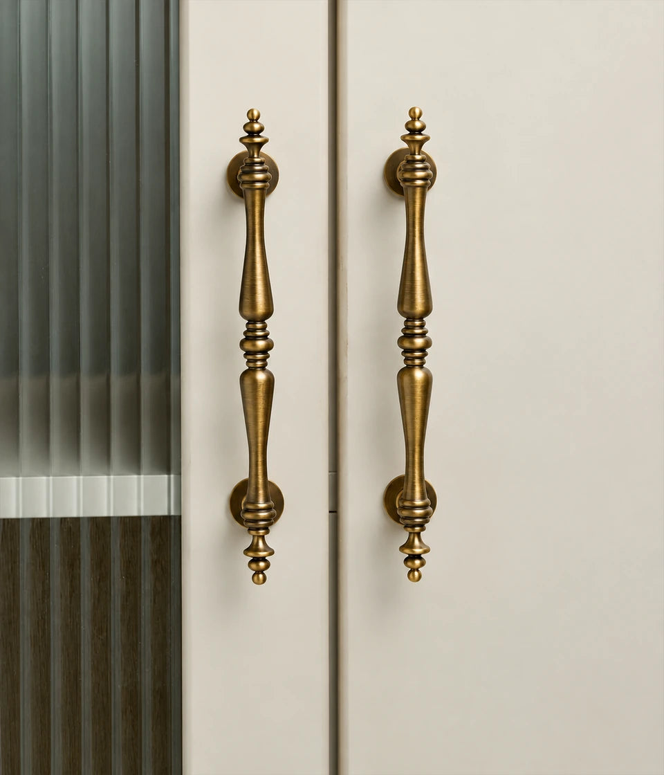 Antique brass finial cabinet pulls installed on cabinet doors