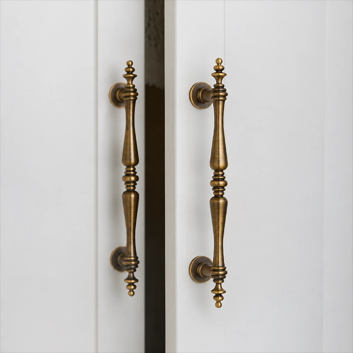 Antique brass finial pull on an open cabinet door
