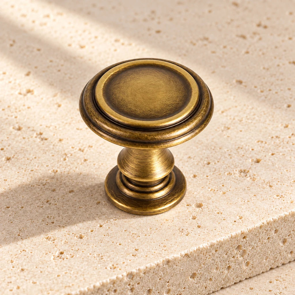 antique brass finial round knob limestone on pale limestone.