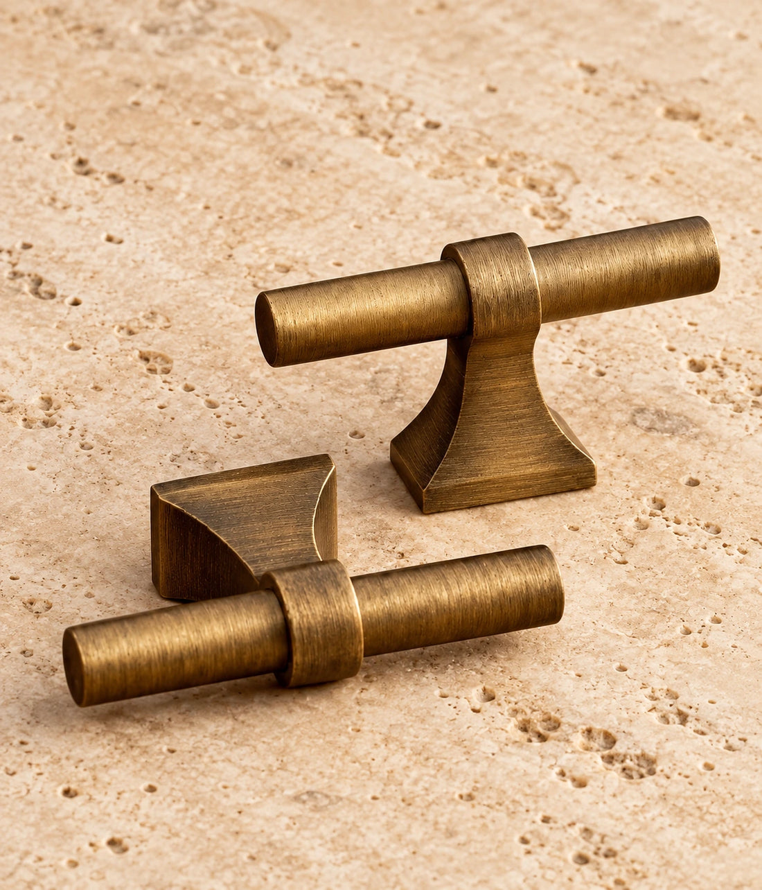Antique Brass Flared Base Cabinet Pulls & T-Knob on warm limestone