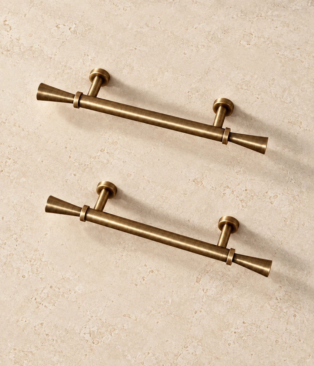 Antique Brass Flared Cabinet Pulls & T-Knob on warm ivory limestone