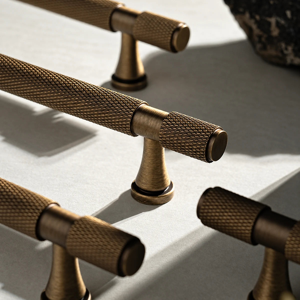 Close-up of cross-knurled brass grip, smooth collar and flared mounting post