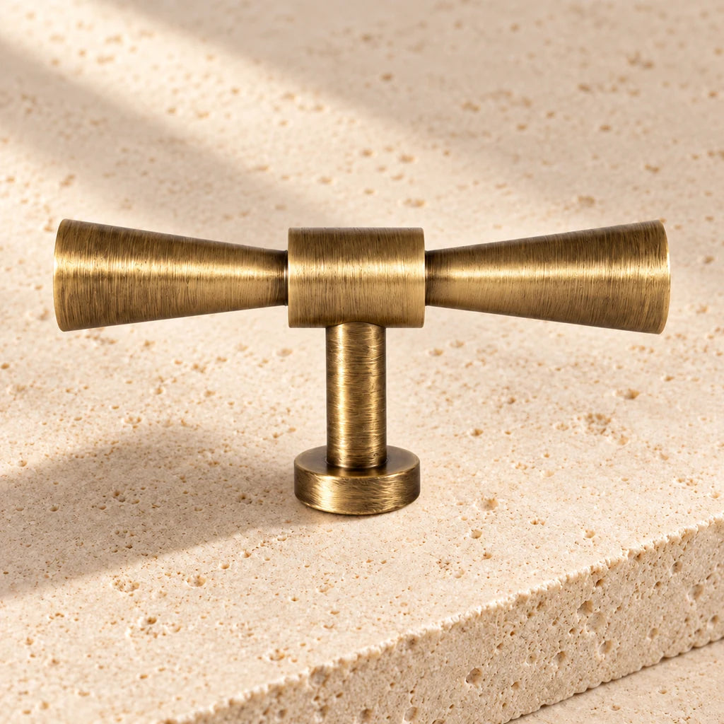 antique brass flared t knob limestone on pale limestone.