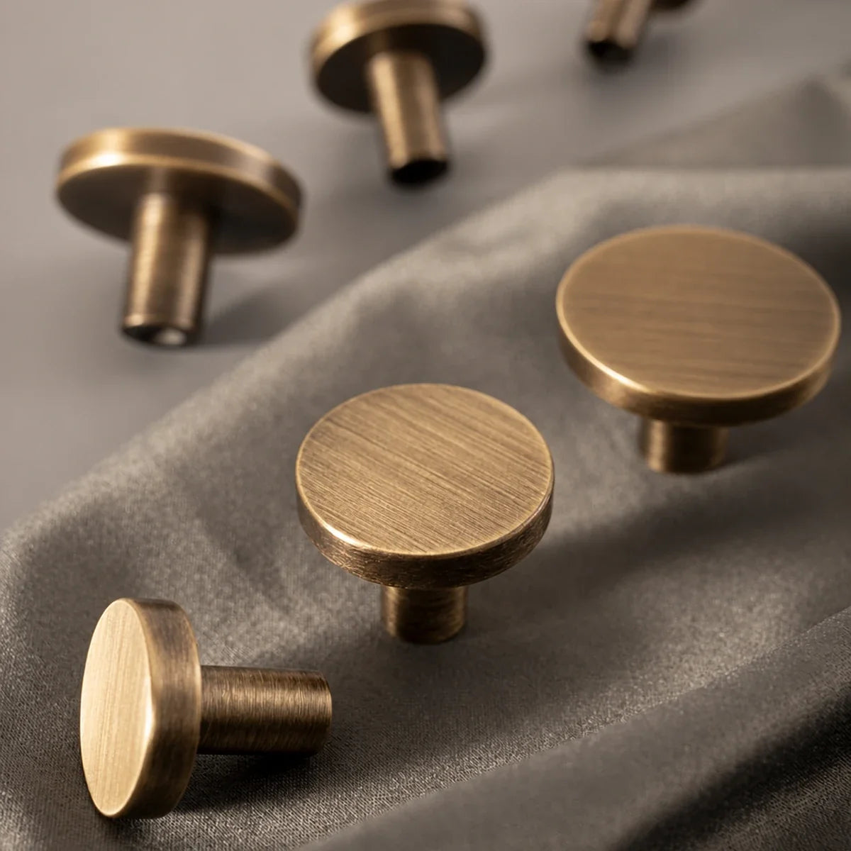 Close-up of solid brass disk knobs in antique brushed brass