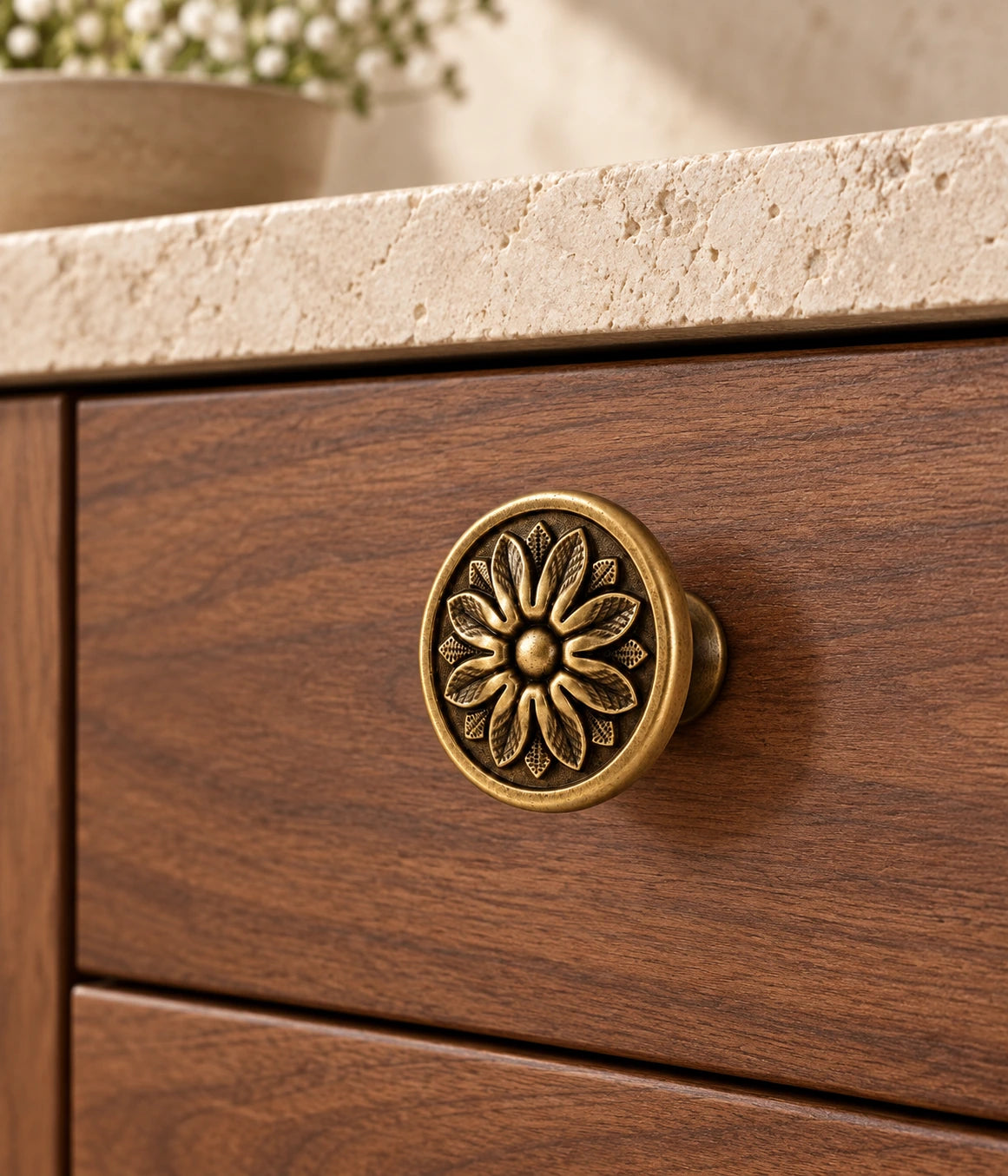 Antique Brass Floral Disc Cabinet Knobs installed on a cabinet drawer