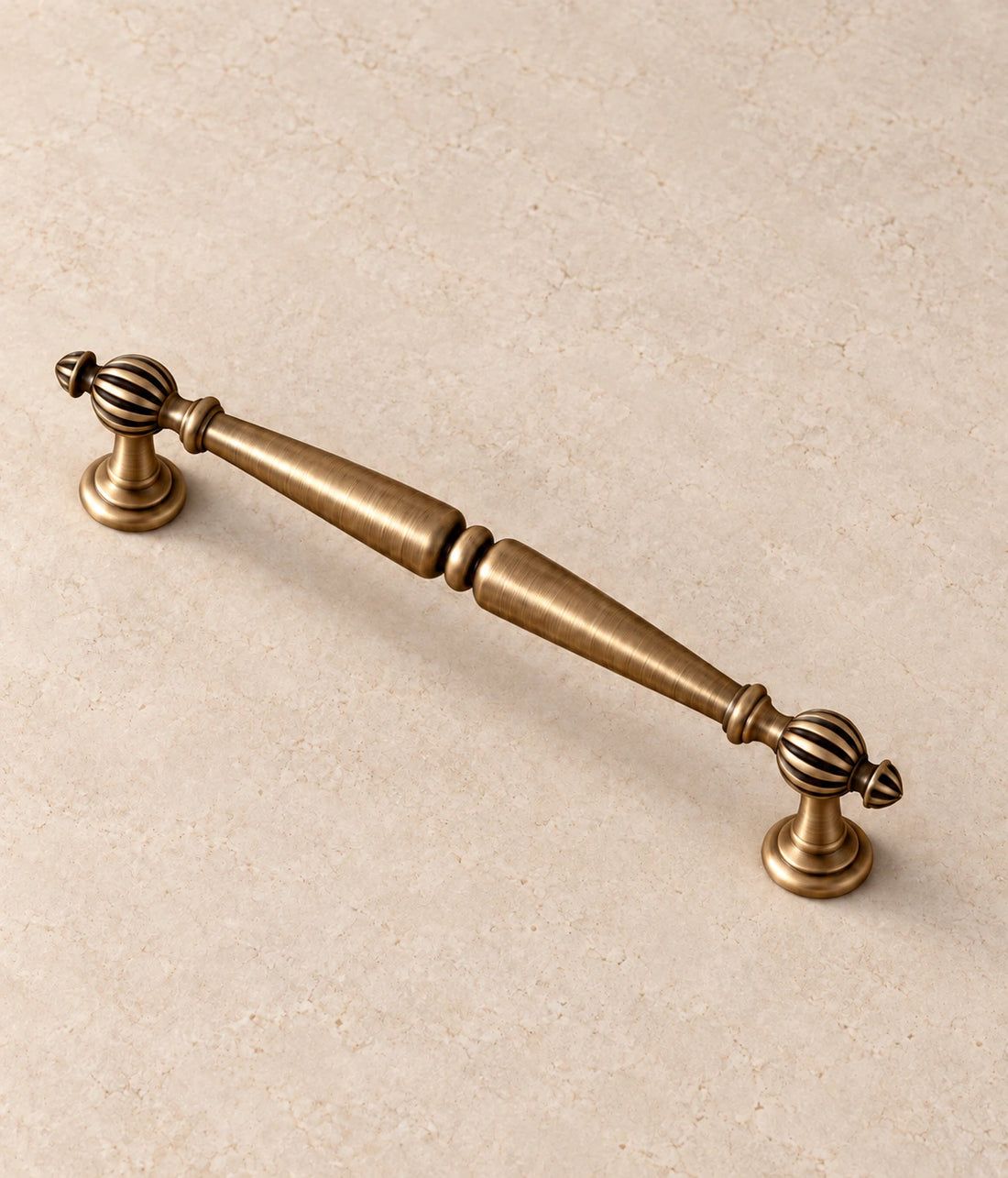 Antique Brass Fluted Ball Cabinet Pulls on warm limestone