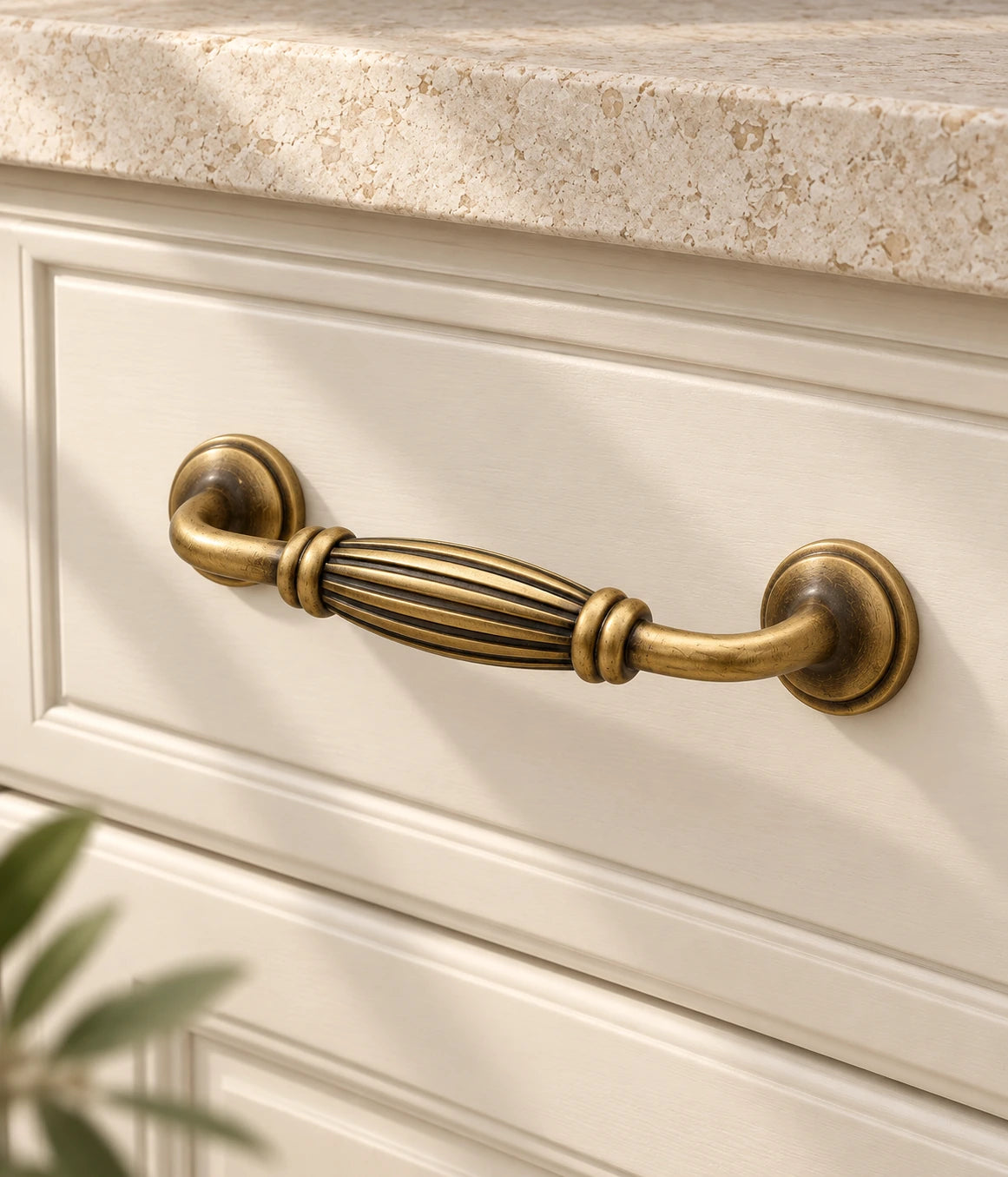 Antique Brass Fluted Barrel Cabinet Pulls & T-Knob installed on an ivory cabinet drawer
