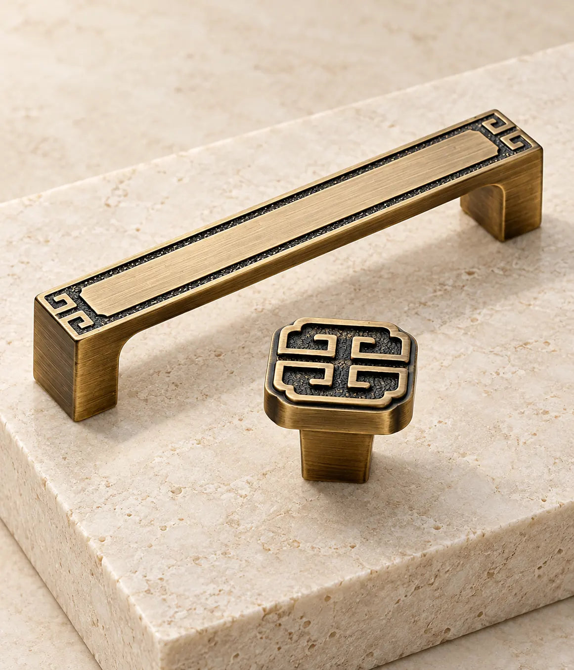 Close detail of recessed geometric motif on solid brass pull and square knob