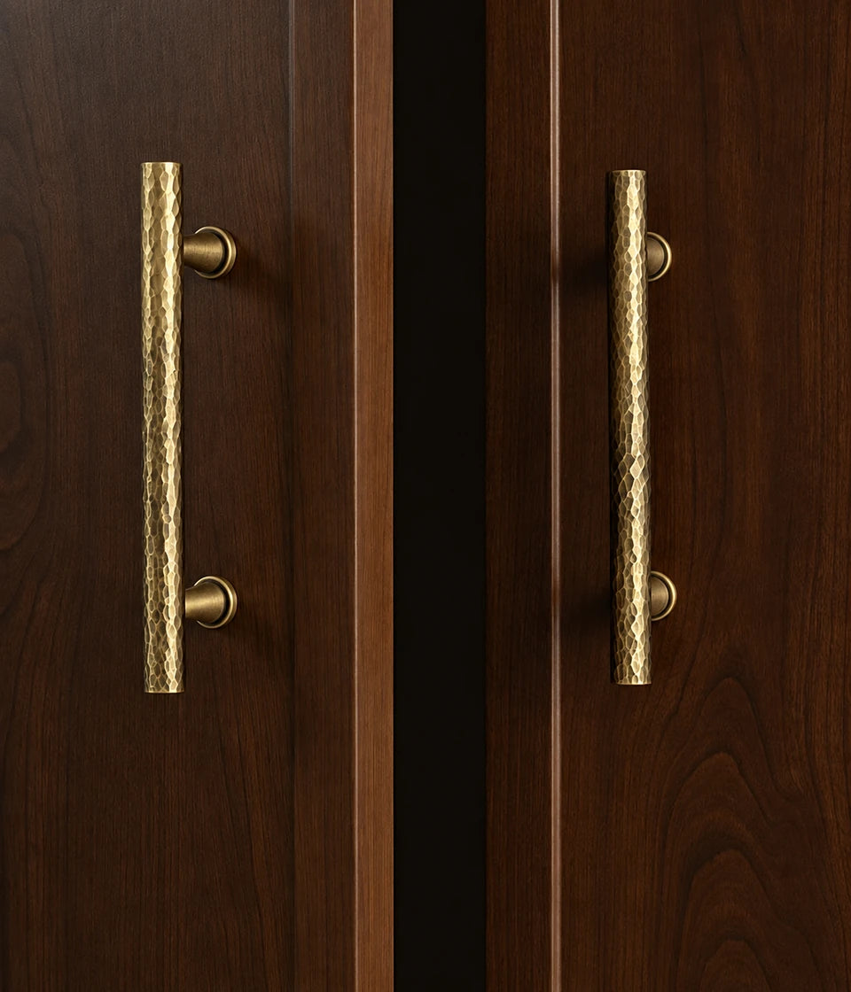 Antique brass hammered bar pulls installed on dark wood cabinet doors