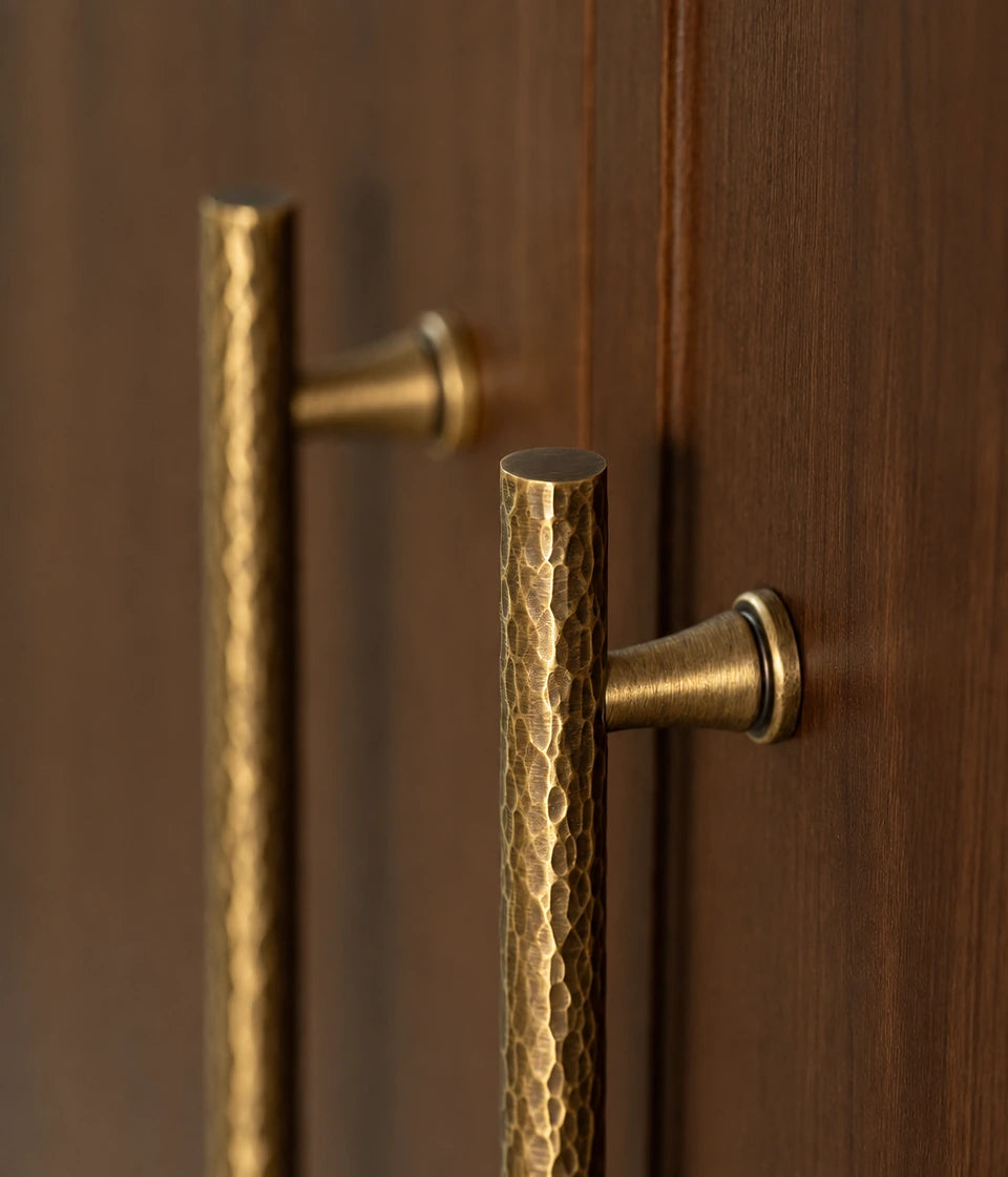 Close-up of the hammered brass grip and flared mounting post