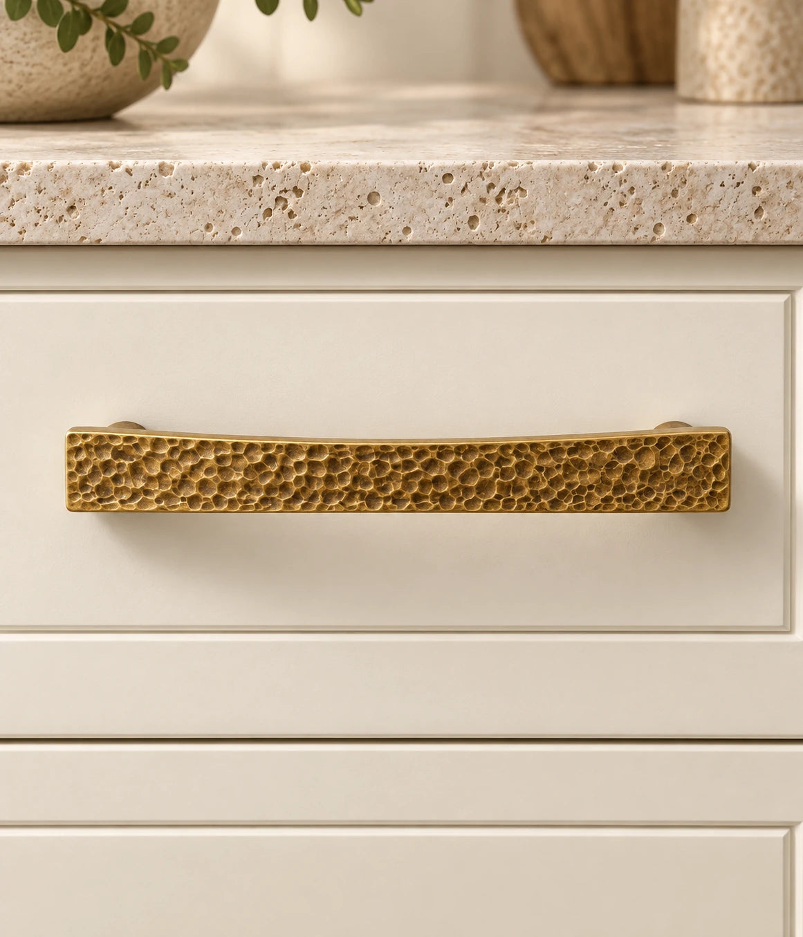 Antique Brass Hammered Rectangular Pulls & Knob mounted on an ivory cabinet drawer