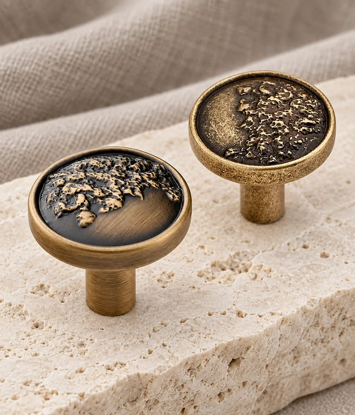 Antique brass organic relief cabinet knobs with brushed and textured rim options on limestone