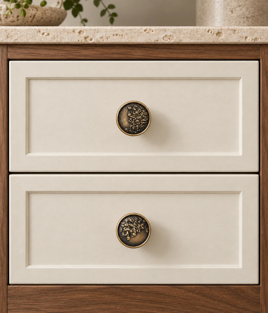 Antique brass organic relief cabinet knobs with brushed and textured rim options on limestone