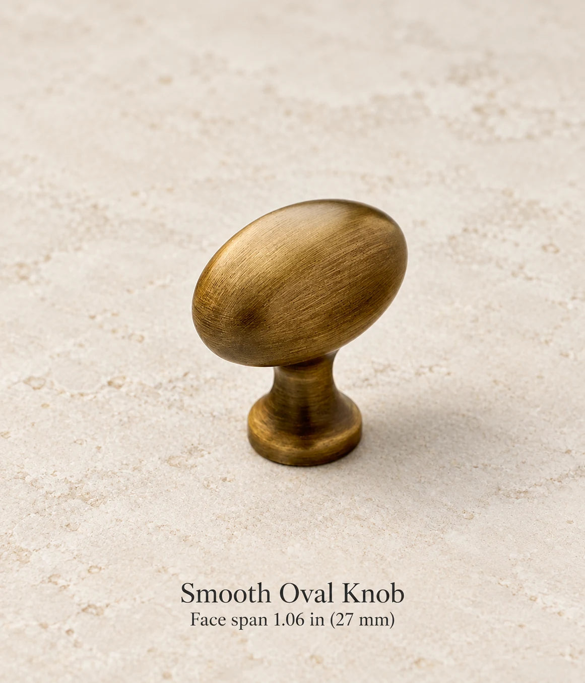 Smooth Oval Knob in antique brass, face span 1.06 in (27 mm)