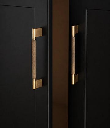 Antique brass knurled cabinet pulls with rectangular bases installed vertically on black doors