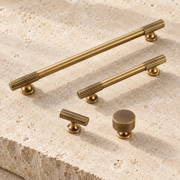 Antique brass reeded-end pulls, T-knob and round knobs on limestone