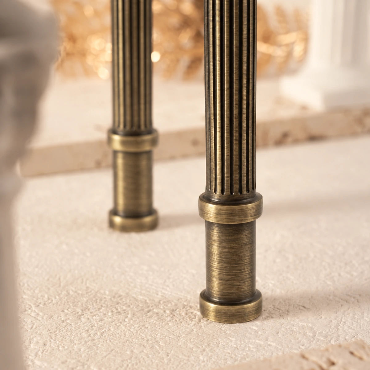 Close-up of lengthwise grooves on antique brass cabinet handle