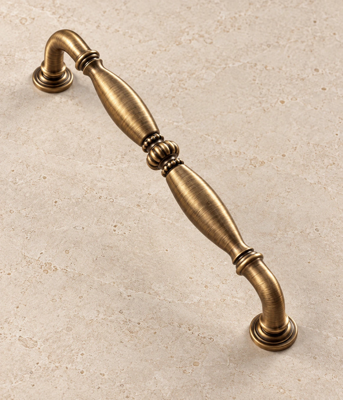 Antique Brass Ribbed Center Cabinet Pulls on warm limestone