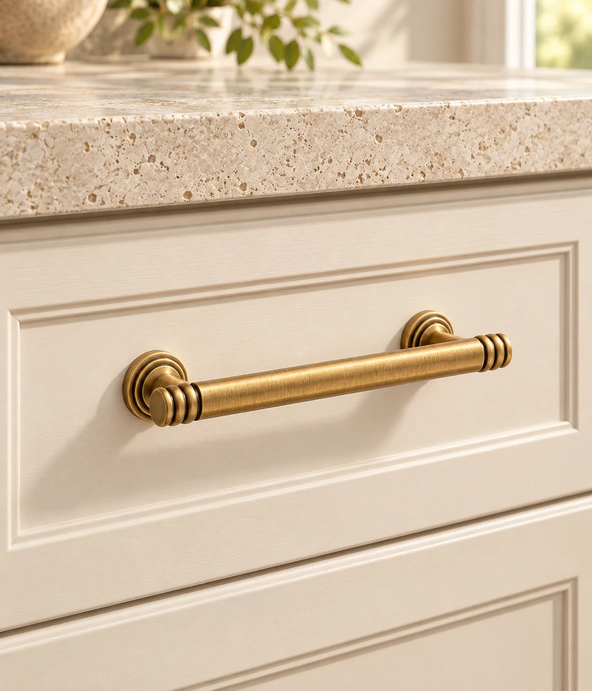 Antique Brass Ring-End Cabinet Pulls & Dished Knobs installed on an ivory cabinet drawer